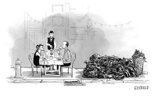 People dine in a restaurant during COVID next to lots of rubbish.