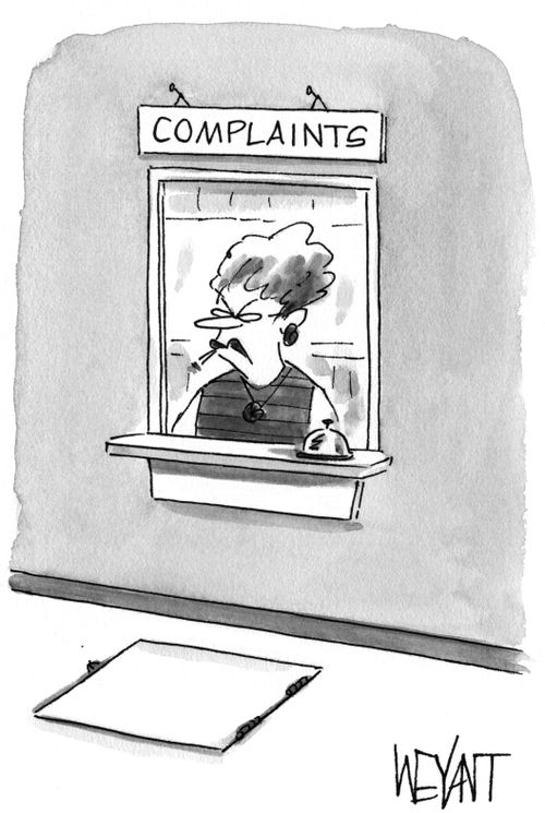 Stern looking woman sitting at a service window labeled "Complaints".