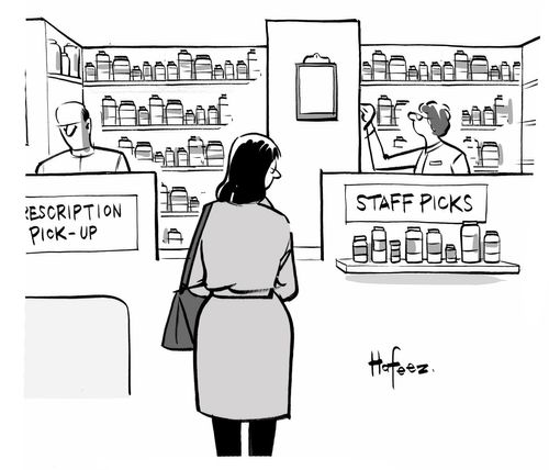 A woman looking at a sign in a pharmacy that says "Staff Picks".