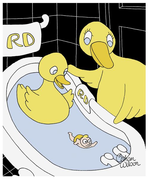 A duckling takes a bath with a rubber human.