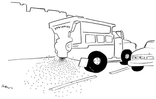 A dump truck spreads sprinkles on the road.