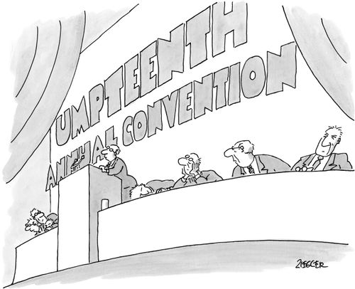 A man giving a speech at the "Umpteenth Annual Convention".