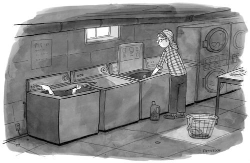 A woman watches hands come out of the washing machine.