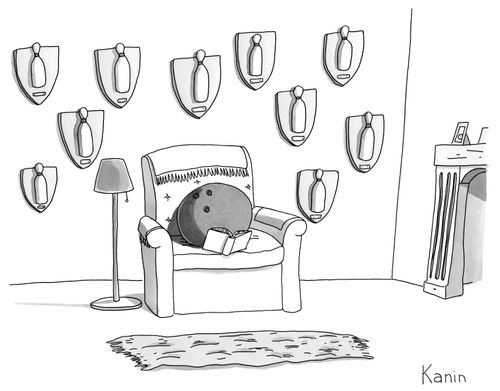 A bowling ball reading in its living room; hunting trophies with mounted bowling pins are hanging on the wall behind it.