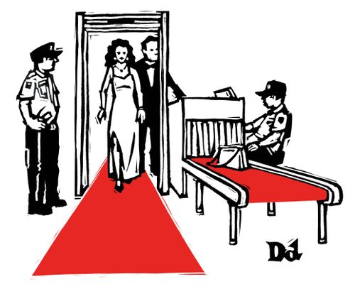 A woman walks the red carpet during a security screening.