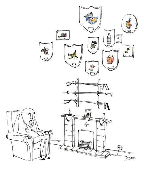 A man sits in an armchair admiring his little pickers and trophies of litter he has picked up which are displayed on the wall.