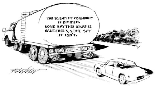 A tanker truck with a warning on the back that reads "The scientific community is divided. Some say this stuff is dangerous, some say it isn't".