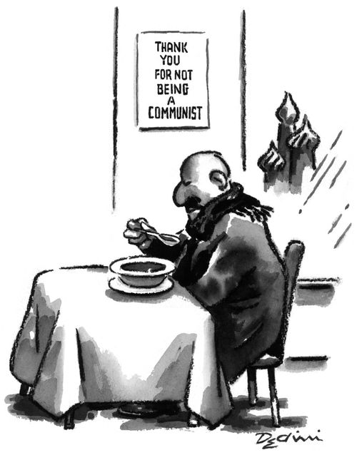 Man eating under a sign which reads "Thank you for not being a Communist".
