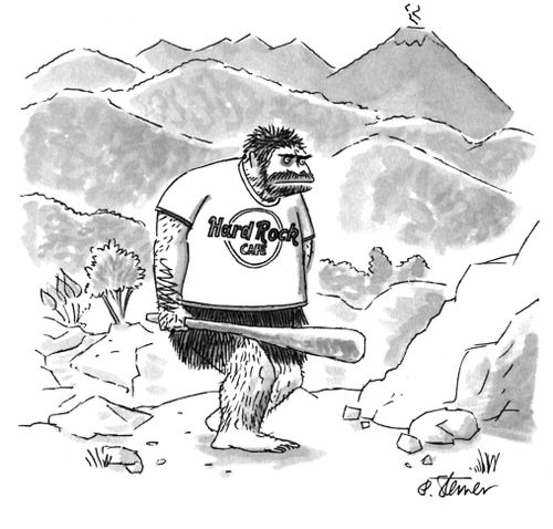 A caveman wears a Hard Rock Cafe t-shirt.