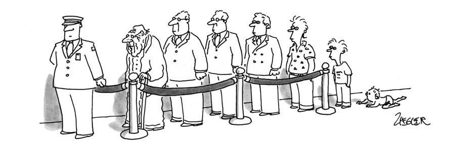 Seven males, ranging in age from a baby to an old man, wait in a line monitored by a uniformed guard.