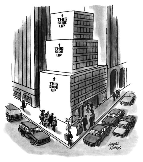 An office building made of different sized boxes stacked on top of one another; each box says "This side up" on the side.