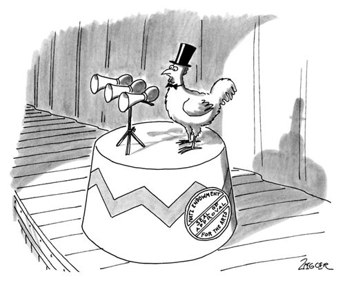 Chicken standing on a platform on a stage with three horns in front of it and wearing a top hat; a sign on the side of the platform reads "National Endowment for the Arts - Seal of Approval."