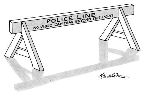 A barricade that reads "Police Line - No video cameras beyond this point."