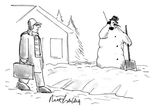 Man walks by a snowman talking on a cellphone