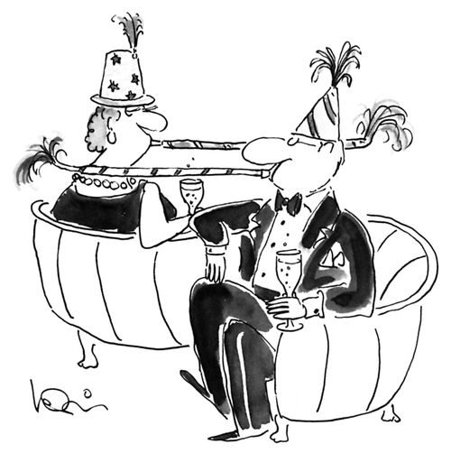 A couple in party hats and party horns on a loveseat