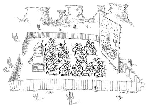 People on horses watch an open air movie