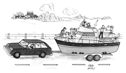 A car towing a yacht full of people partying down a rural road.