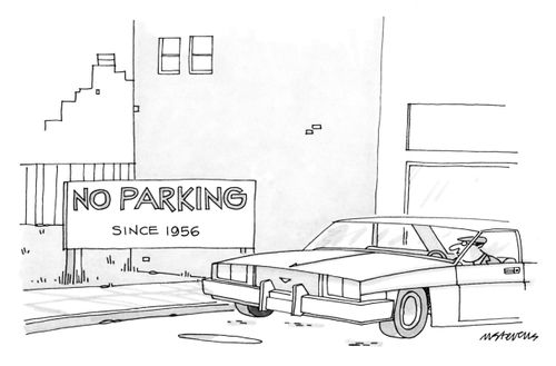 A man drives past a sign on a vacant lot that reads "No Parking - Since 1956".