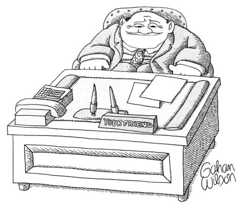 Man at a desk with a sign reading "Your Friend"