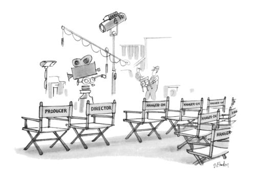 Two chairs on a film set labeled with "Producer" and "Director" next to rows of chairs labeled "Hanger-on"