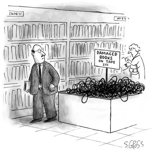 Man in a bookstore looking at a bin of unwound cassette tapes with a sign reading "Damaged books on tape  25¢".