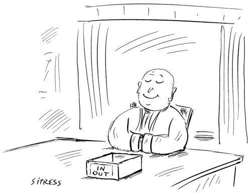 A buddhist monk sits with an empty in/out box