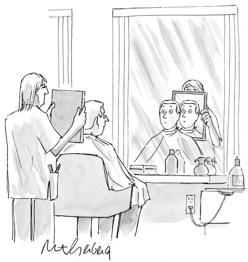Man looking in mirror at the barber's.