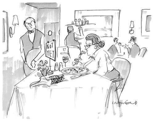 A waiter looks annoyed at a woman eating with a 'not yet' sign on her table.