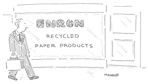 A man walks past a storefront that reads "ENRON - Recycled paper products."