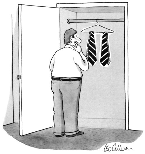 A man trying to decide which tie he should put on.
