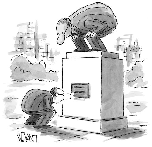 Man crouches over to read plaque.