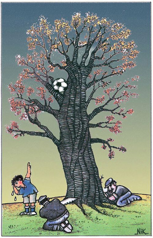 Men cut down a tree to retrieve a football.