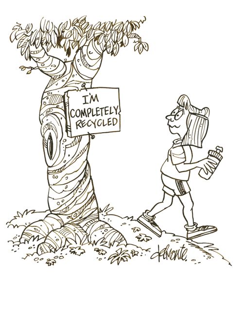Tree in a park with a sign on it: I'm Completely Recycled.