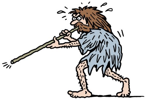 A cave man blowing down a blowpipe.