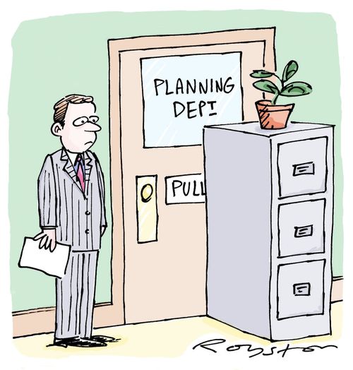 Man in office notices file cabinet placed in front of the door to the Planning Department.