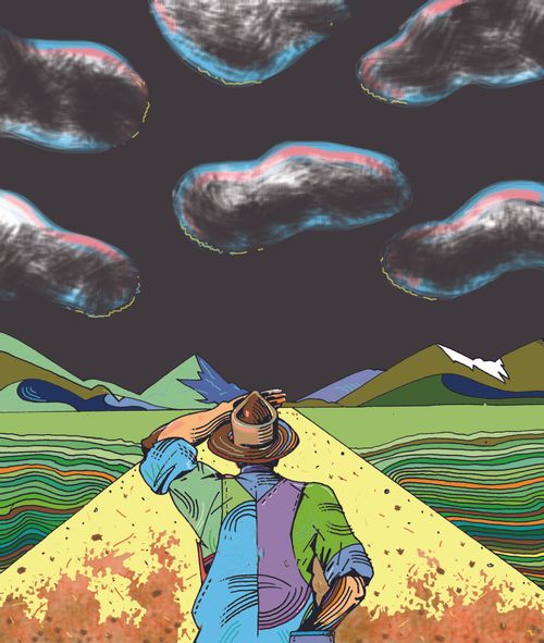 Man looking down a road with storm clouds above.