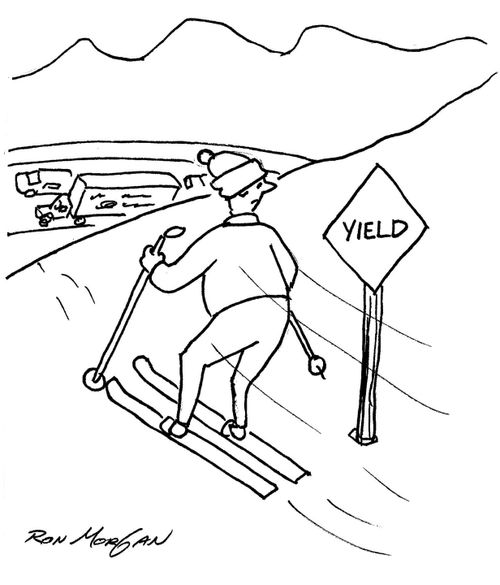 Skier sees yield sign at top of slope and a major highway is on other side of slope.