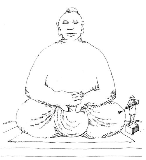 Buddist using metal detector on statue of Budda