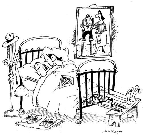 Stilt walking man in bed with his stilts still on