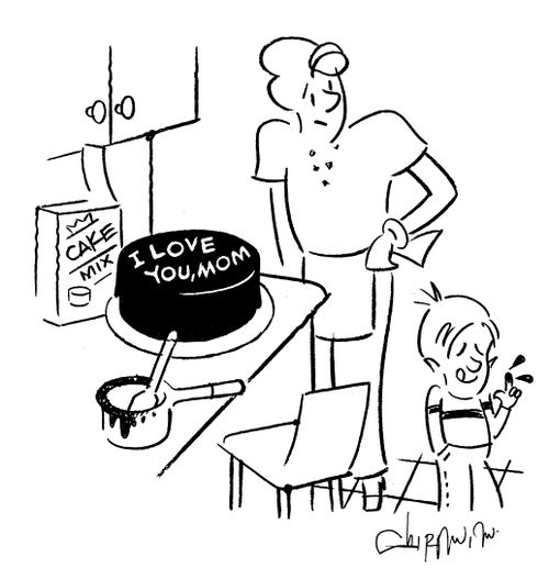 Boy ices cake with 'I love you Mom'.
