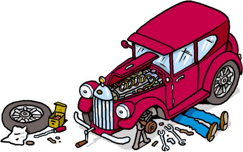 A vintage car being fixed by a mechanic underneath.
