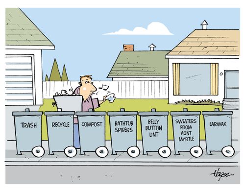 A man separates his garbage into seven different bins.