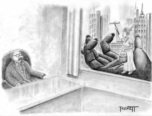 An exec sitting at desk looking out his window cleaner.