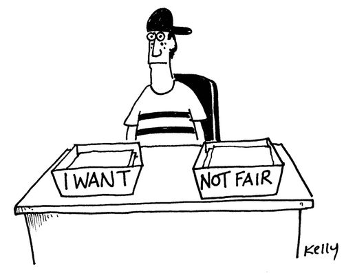 Teenager sitting at desk with in/out tray which read:'I want' and 'Not fair'