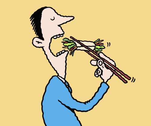 A man eating vegetable roll with chopsticks