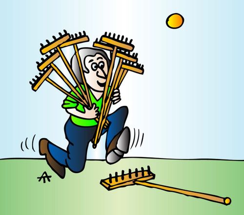 Man carrying lots of brushes is about to trip over one.