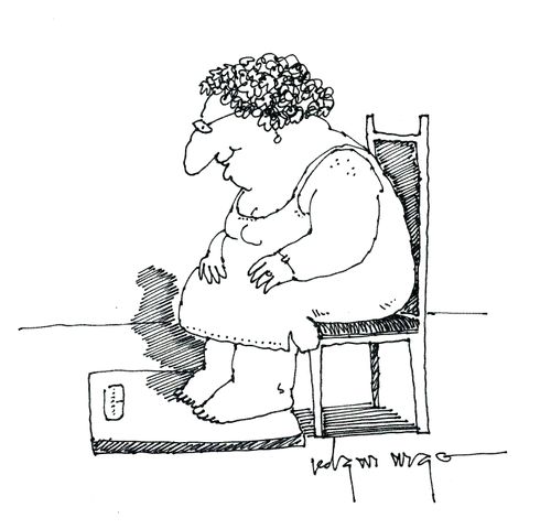 Woman weighing herself sitting on a chair.