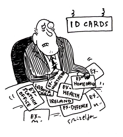 John Reid with his old ID cards.