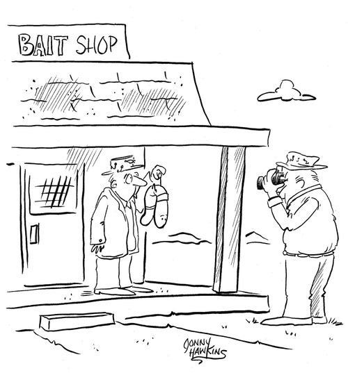 Man takes picutre of other man holding up huge worm at Bait Shop.
