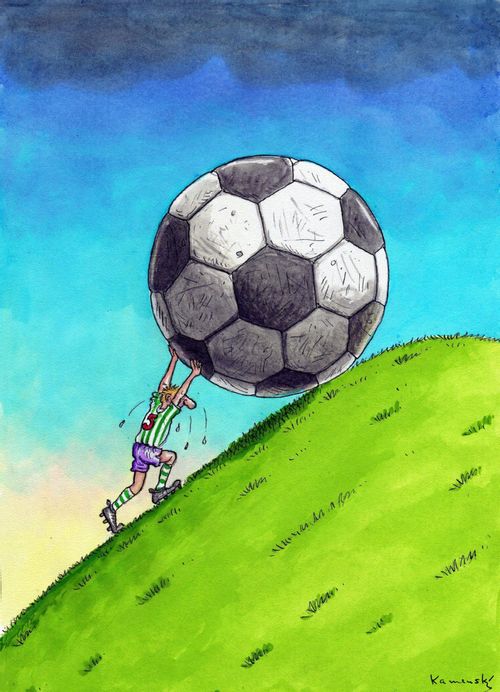 Footballer pushes a giant football up the hill.